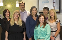 Mike Brzozowski and Jill Balderson at center, with HealthEd management team 