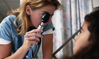 A clinician administers an eye exam. (credit: PhotoDisc) A clinician administers an eye exam. (credit: PhotoDisc)